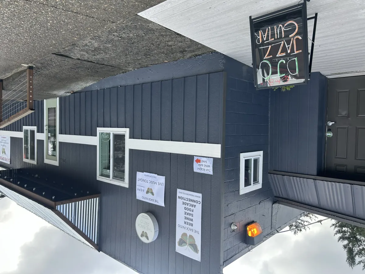 Live music A-frame sign and event flyers outside The Back Patio