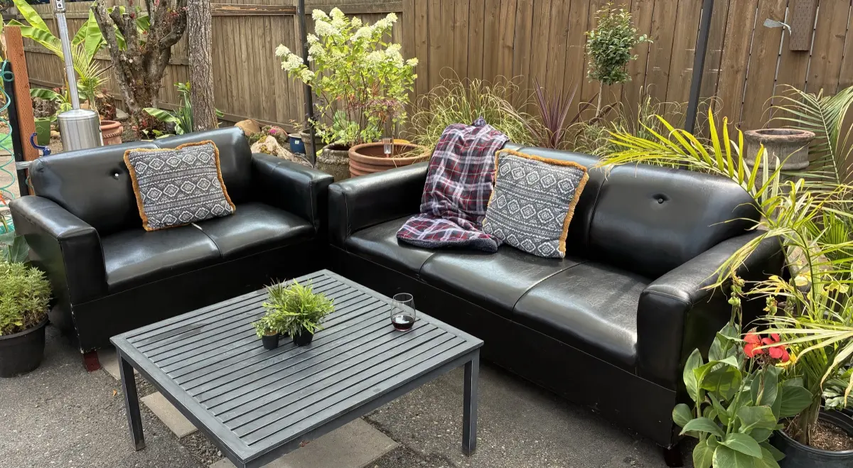 Secret garden patio with outdoor lounge sofas and greenery
